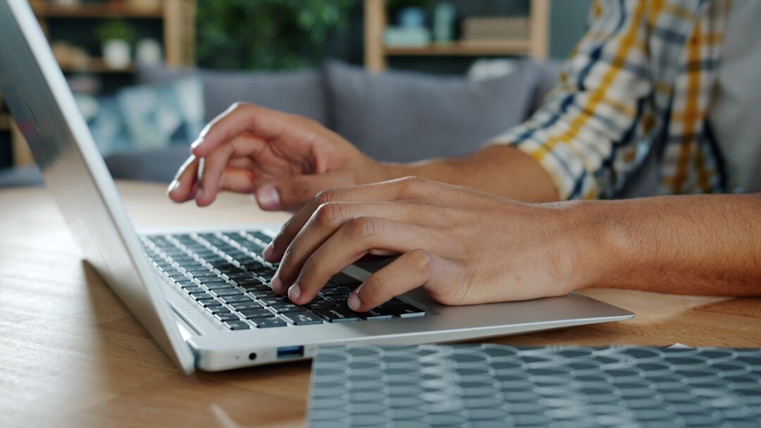 writer typing on laptop at desk