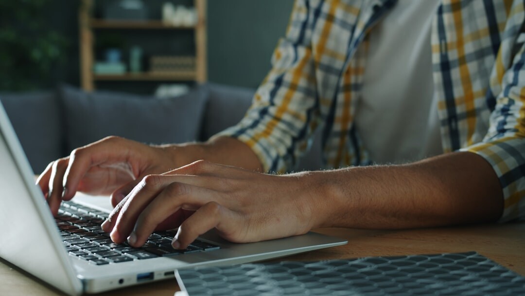 writer typing on laptop at desk
