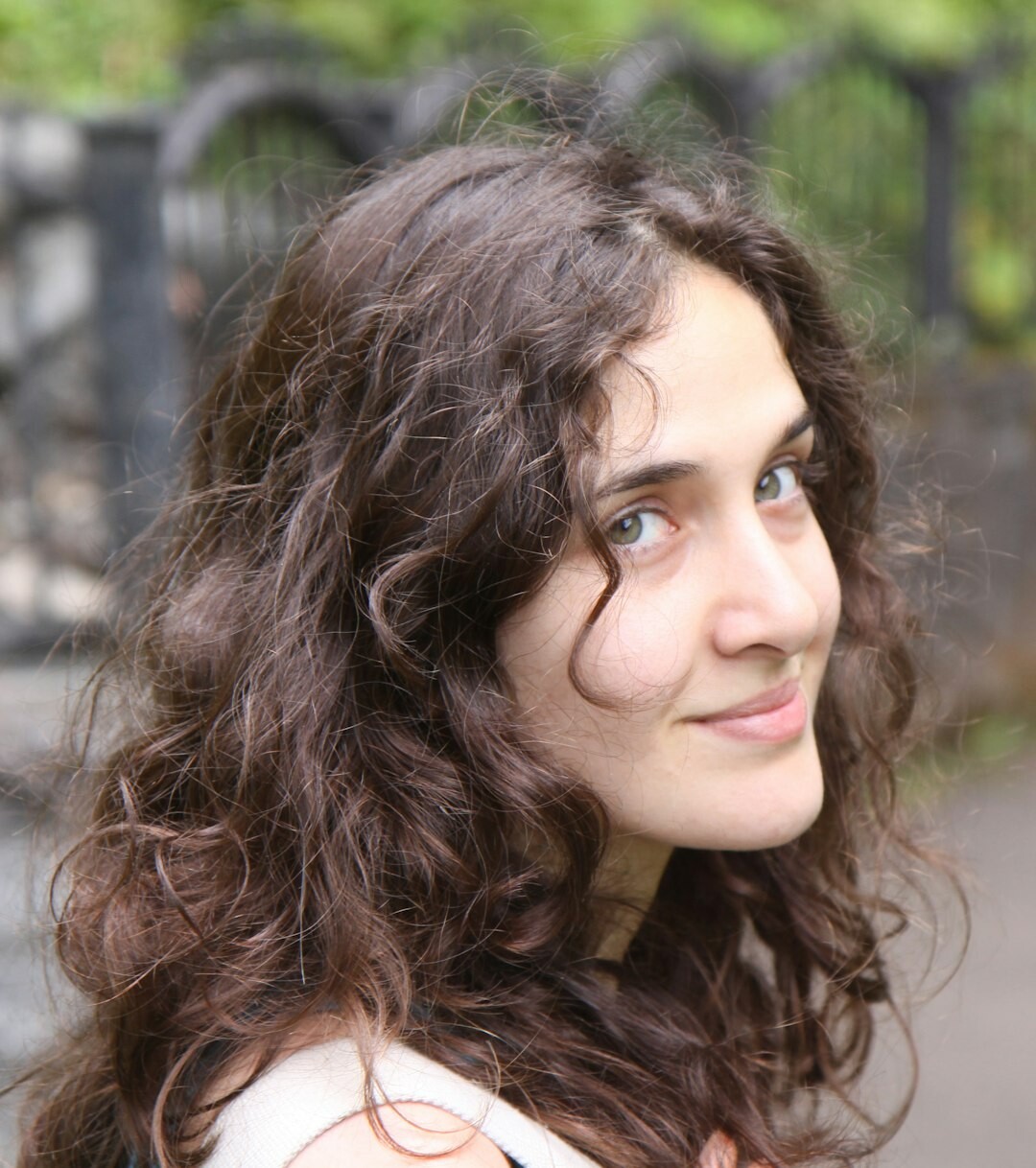 Portrait of a young woman with curly hair smiling