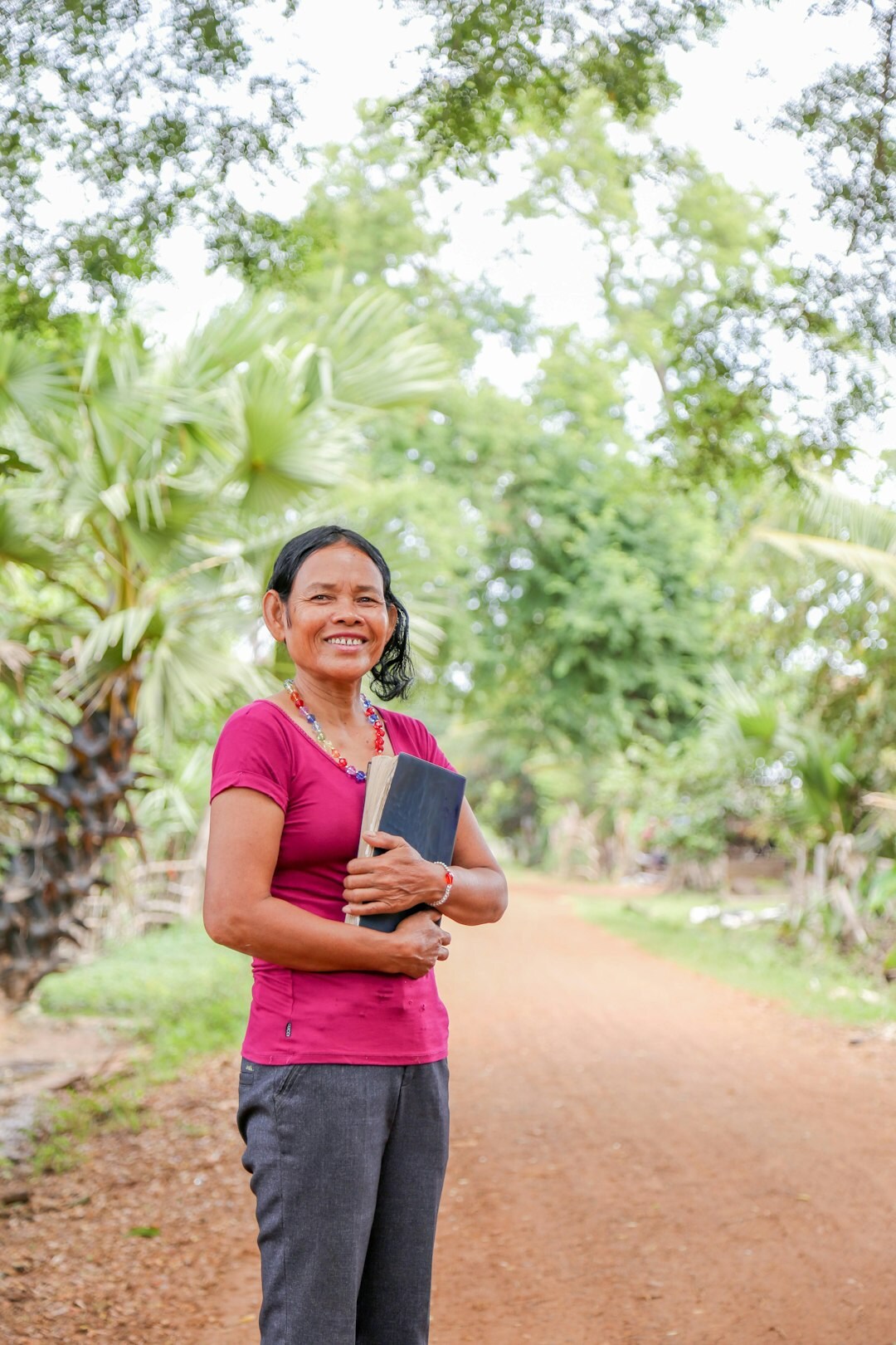 Portrait of a smiling middle-aged woman holding a book