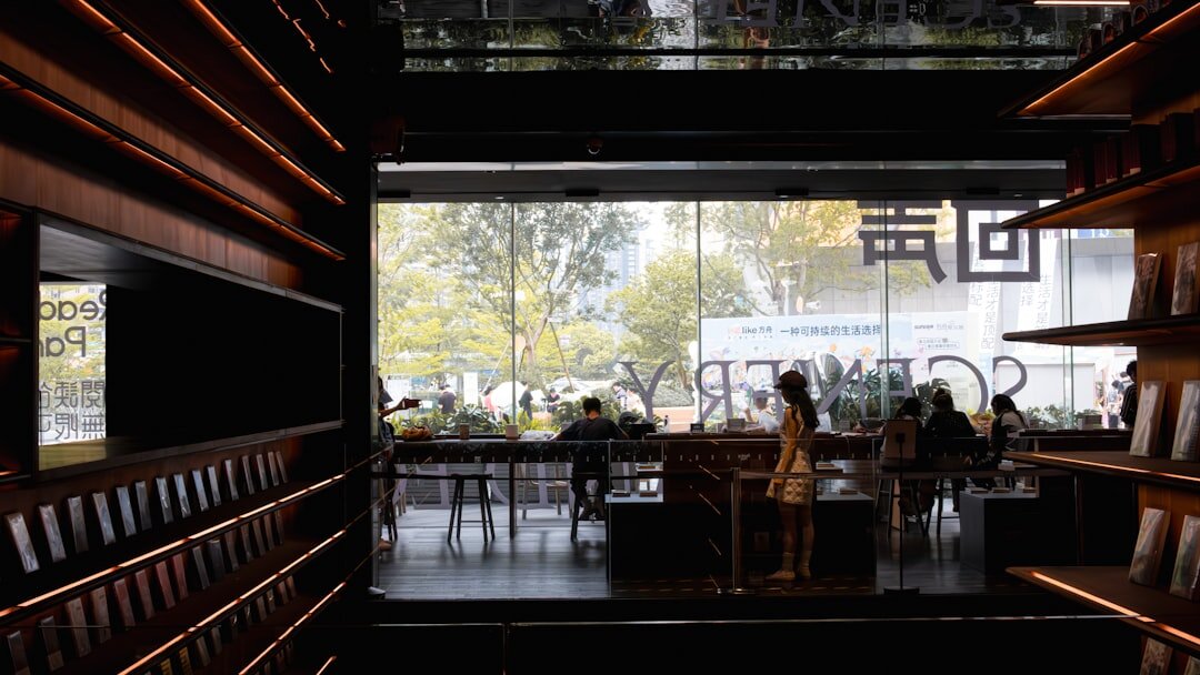 person reading book in cafe
