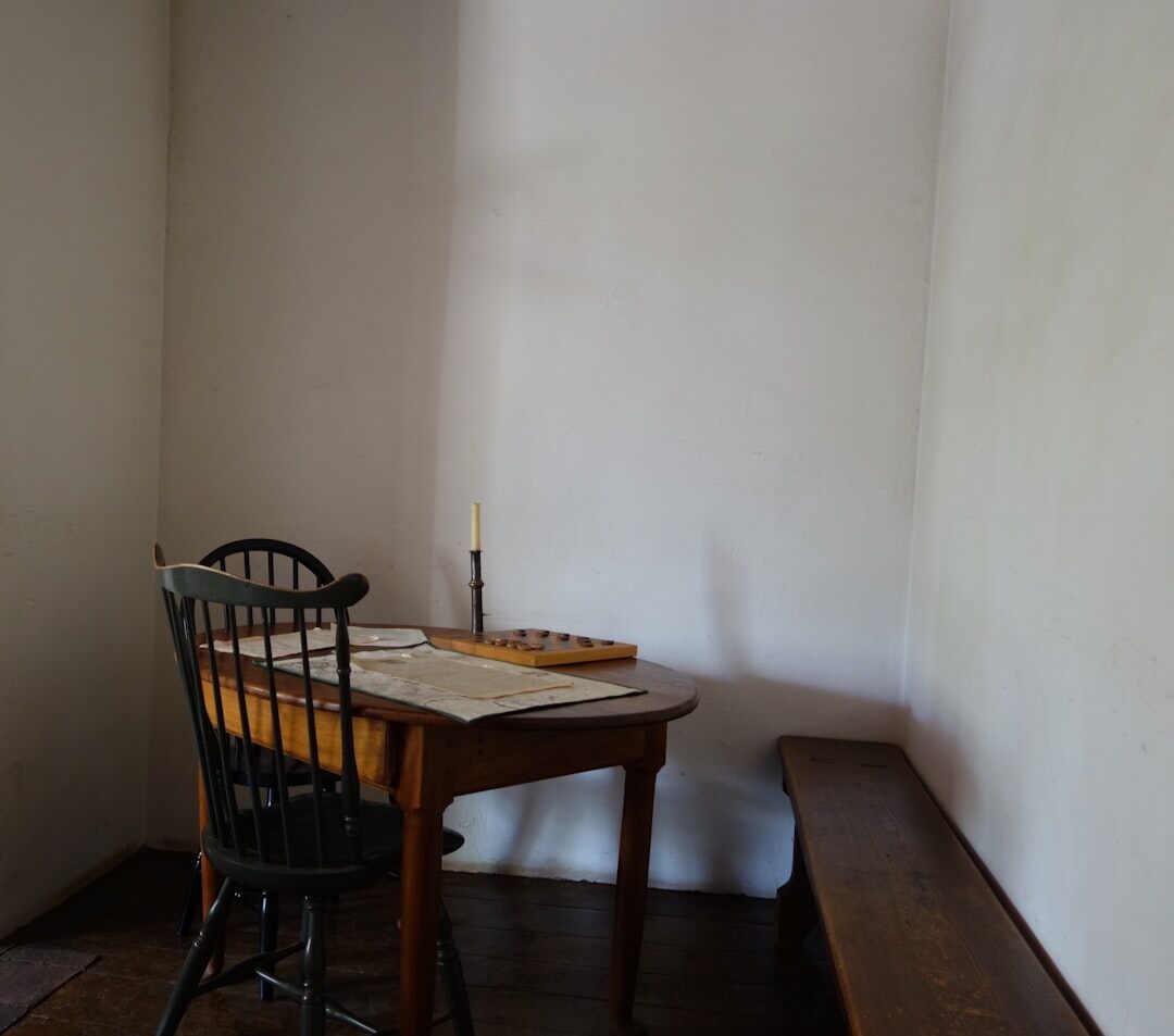 Vintage wooden writing desk with a typewriter, notebook and candle