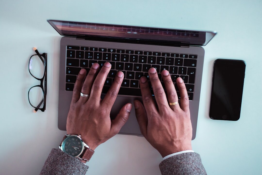 mystery writer typing on laptop